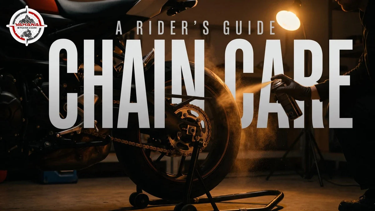 Motorcycle chain and rear sprocket being lubricated in a warmly lit workshop