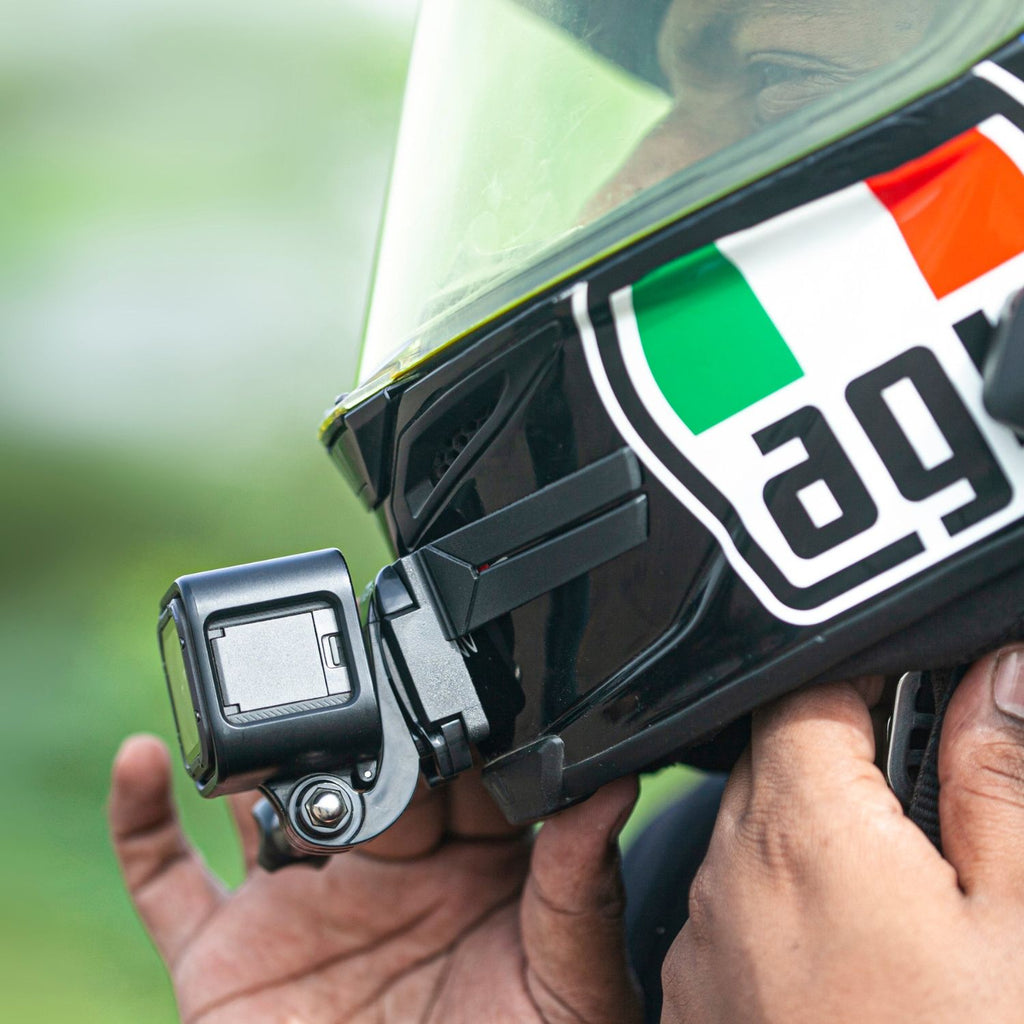Black chin mount holding an action camera on the helmet front