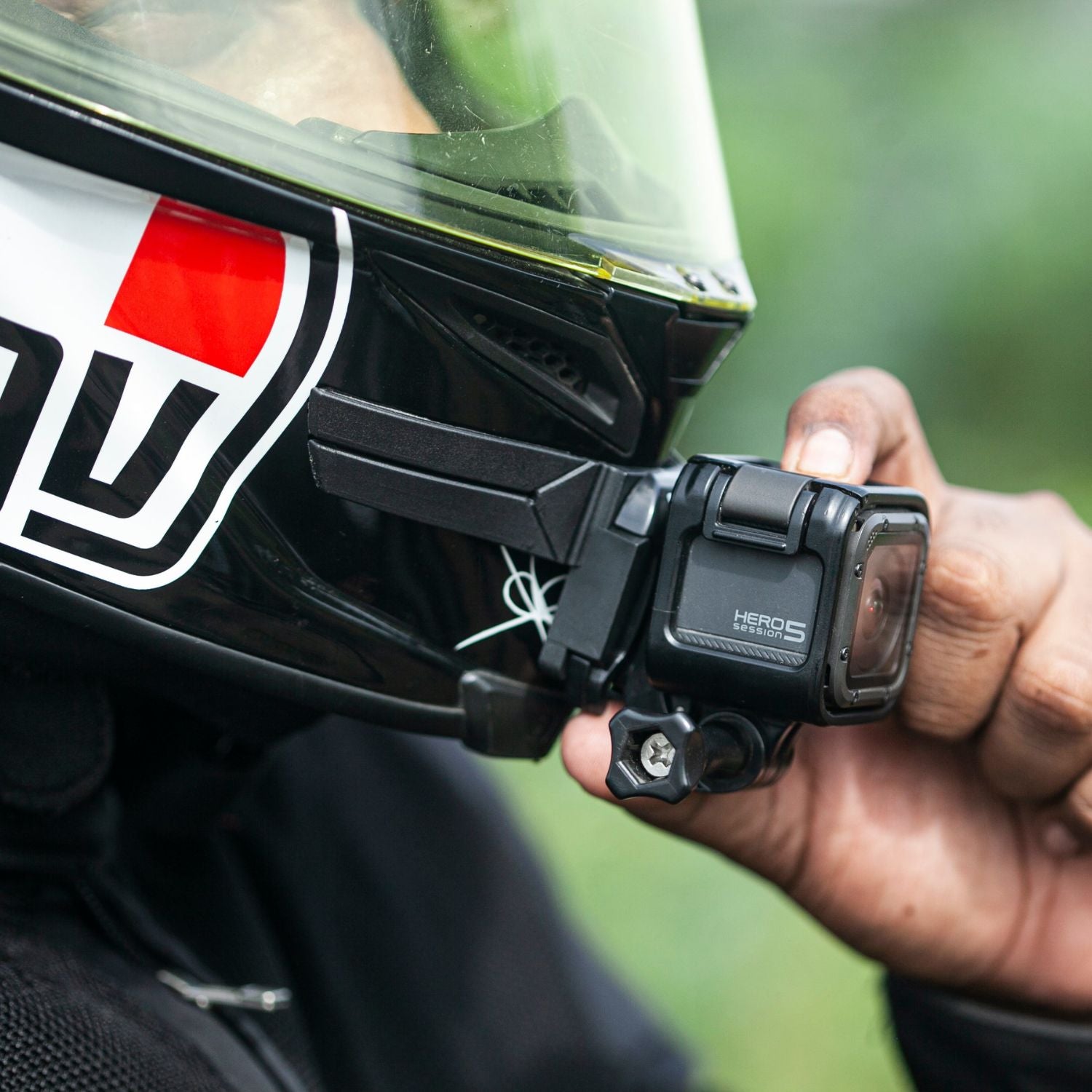 Black chin mount with action camera secured by side clamp and screw