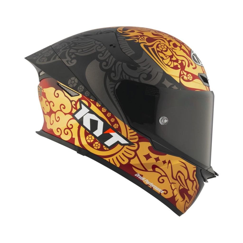 Matt black full-face motorcycle helmet with orange-gold front graphics and tinted visor