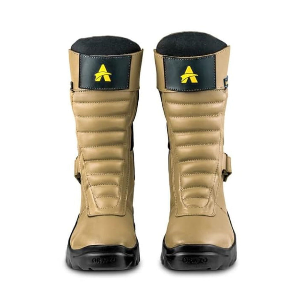 Camel riding boots with black collar trim, yellow logo on cuff, and chunky outsole.